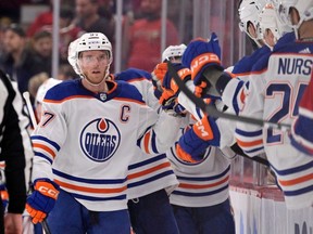 Edmonton Oilers forward Connor McDavid (97) celebrates with teammates after scoring a goal against the Montreal Canadiens during the second period at the Bell Centre on Sunday, Feb. 12, 2023.