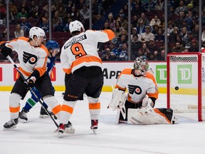 Vancouver Canucks forward Andrei Kuzmenko and Philadelphia Flyers defenceman Travis Sanheim and defenceman Ivan Provorov and goalie Carter Hart watch the shot from Canucks forward Anthony Beauvillier get past Hart in the first period at Rogers Arena. Feb. 18, 2023.