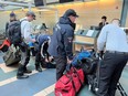 Handout photo of Burnaby firefighters and the Urban Search and Rescue team checking in at YVR on Feb. 8, 2023. The team is traveling to Turkey to aid in the search and rescue of survivors following the magnitude 7.8 earthquake that struck Turkey and Syria on Monday, Feb. 6, 2023.