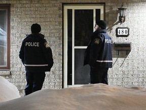 Police are shown outside the home of Pierre Ny St-Amand in Laval, Que, Wednesday, Feb. 8, 2023.