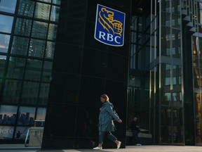 Statistics Canada will release December and fourth quarter gross domestic product figures this morning. A person walks past RBC signage in Toronto on Tuesday, Sept. 20, 2022.