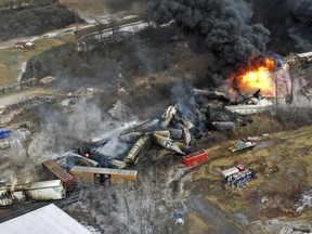 In this photo taken with a drone, portions of a Norfolk Southern freight train that derailed the day before in East Palestine, Ohio, remain on fire at mid-day on Feb. 4, 2023.