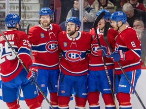 Canadiens' Jonathan Drouin, centre, celebrates his goal with teammates during a win over the Lightning Tuesday at the Bell Centre. Former GM Serge Savard has been impressed with how the injury-ravaged Habs have been competitive this season.