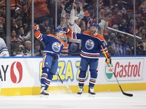 Edmonton Oilers' Connor McDavid (97) and Mattias Ekholm (14) celebrate a goal against the Toronto Maple Leafs.