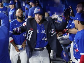 George Springer of the Toronto Blue Jays celebrates his home run with the blue jacket in the dugout against the New York Yankees in the first inning during their MLB game at the Rogers Centre on September 27, 2022 in Toronto, Ontario, Canada.