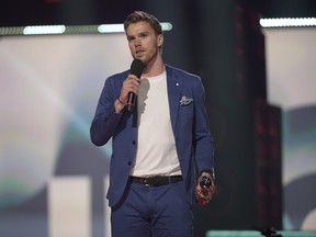 Connor McDavid presents Nickelback with their induction into the Canadian Music Hall of Fame at the 2023 Juno Awards at Rogers Place on March 13, 2023 in Edmonton.