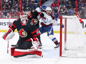 Mads Sogaard of the Senators tracks the puck after making a first-period save against the Avalanche on Thursday night.