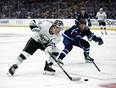 Blake Lizotte takes a puck to the net with Vlad Namestnikov of the Jets in pursuit on Saturday. Lizotte was suspended Sunday for his cross-check to the face of Jets' defenceman Josh Morrissey.