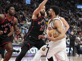 Toronto Raptors forward O.G. Anunoby (3) and guard Fred VanVleet (23) defend against Denver Nuggets guard Jamal Murray (27) during the second half at Scotiabank Arena Mar 14, 2023. John E. Sokolowski-USA TODAY Sports