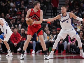 Raptors centre Jakob Poeltl controls the ball as Washington Wizard' Kristaps Porzingis tries to defend during the fourth quarter at Scotiabank Arena on Sunday.