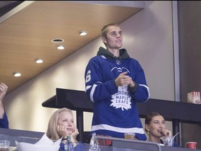 Justin Bieber watches alongside his wife Hailey Baldwin, far right, during NHL hockey action between the Philadelphia Flyers and the Toronto Maple Leafs, in Toronto on Saturday, Nov. 24, 2018.