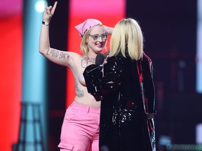Avril Lavigne confronts a topless protester as she presents during the Junos Monday, March 13, 2023.