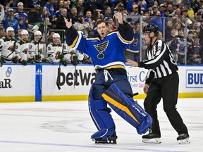 Blues goaltender Jordan Binnington hypes up the crowd after he was ejected from the game during the second period against the Wild at Enterprise Center in St. Louis, Wednesday, March 15, 2023.