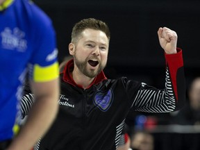 Ontario skip Mike McEwen celebrates after using the hammer to score two points in the 10th end for a 9-8 win over Alberta in a crossover elimination game at the Tim Hortons Brier at Budweiser Gardens in London on Friday, March 10, 2023. (Derek Ruttan/The London Free Press)