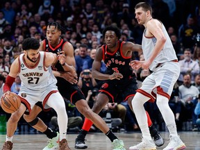 Denver Nuggets guard Jamal Murray (27) gets tied up with Toronto Raptors forward Scottie Barnes (4) as forward O.G. Anunoby (3) and center Nikola Jokic (15) defend in the fourth quarter at Ball Arena.