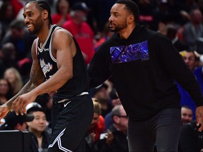 Former Raptors and now Los Angeles Clippers forward Kawhi Leonard (2) and guard Norman Powell celebrate after Leonard scored a basket against the Raptors during the second half at Crypto.com Arena.