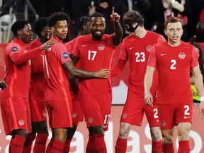 Canada forward Cyle Larin (No. 17) celebrates his goal against Honduras with teammates during Tuesday's game at BMO Field.