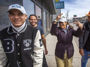 After entering Canada at Roxham Rd, an irregular border crossing in Quebec, Lorey, from Colombia (middle), goes out for a walk with other asylum seekers, who are some of the thousands that have been transported to hotels in Niagara Falls, Ont., out for a walk on Friday, March 24, 2023.