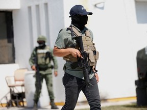 A member of the Attorney General's Office of the State of Tamaulipas guards outside its building in Mexico, March 8, 2023.