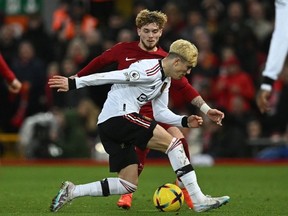 Manchester United's Argentinian midfielder Alejandro Garnacho vies with Liverpool's English midfielder Harvey Elliott during the English Premier League football match between Liverpool and Manchester United at Anfield in Liverpool, north west England on March 5, 2023.