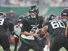 Nov 27, 2022; East Rutherford, New Jersey, USA; New York Jets quarterback Mike White hands the ball off during the second half against the Chicago Bears at MetLife Stadium.
