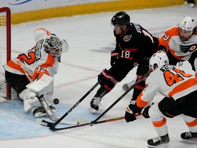 Flyers goaltender Felix Sandstrom makes a save on Senators centre Tim Stutzle as defencemen Cam York and Ivan Provorov defend during the first period of Thursday's game.
