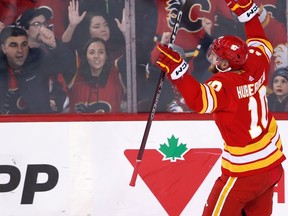 Calgary Flames forward Jonathan Huberdeau and fans celebrate his goal against the Ottawa Senators at Scotiabank Saddledome in Calgary on Sunday, March 12, 2023.
