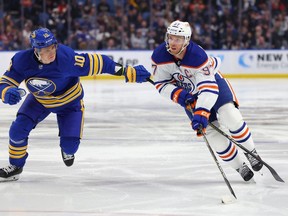 Edmonton Oilers center Connor McDavid (97) skates with the puck as Buffalo Sabres defenceman Henri Jokiharju (10) defends during the third period at KeyBank Center on March 6, 2023.