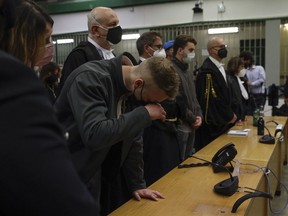 Finnegan Lee Elder, wipes his eye, as he and his co-defendant Gabriel Natale-Hjorth listen as the verdict is read, in the trial for the slaying of an Italian plainclothes police officer on a street near the hotel where they were staying while on vacation in Rome in summer 2019, in Rome, on May 5, 2021.