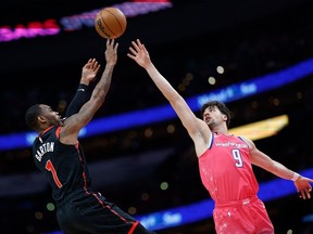 Raptors' Will Barton (left) shoots the ball as Wizards' Deni Avdija defends in the second quarter at Capital One Arena on Thursay, March 3, 2023.