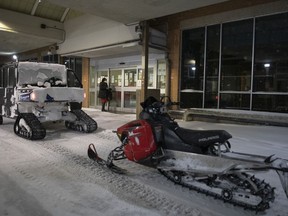 Members of the Saskatoon Fire Department use snowmobiles are shown at St. Paul's Hospital during a snowstorm in Saskatoon, Sask. on Sunday, November 8, 2020.
