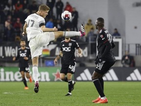 Feb 25, 2023; Washington, District of Columbia, USA;Toronto FC defender Sigurd Rosted clears the ball from D.C. United forward Christian Benteke in the second half at Audi Field.