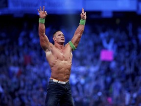 FILE- John Cena celebrates his win during Wrestlemania XXX in New Orleans on April 6, 2014. Cena has been revealed as this year's WWE 2K23 video game cover star. The wrestling game is out Tuesday, March 14, 2023.