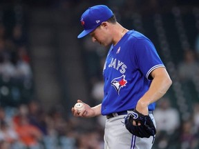 Nate Pearson of the Toronto Blue Jays looks down prior to being pulled during the third inning against the Houston Astros at Minute Maid Park on May 09, 2021 in Houston, Texas.