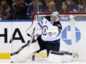 NEW YORK, NEW YORK - FEBRUARY 20: Connor Hellebuyck #37 of the Winnipeg Jets makes the third period save against the New York Rangers at Madison Square Garden on February 20, 2023 in New York City. The Jets defeated the Rangers 4-1. (Photo by Bruce Bennett/Getty Images)