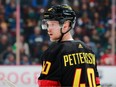 Elias Pettersson #40 of the Vancouver Canucks looks up ice during their NHL game against the Calgary Flames at Rogers Arena April 8, 2023 in Vancouver.