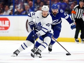 Jake McCabe of the Toronto Maple Leafs and Nicholas Paul of the Tampa Bay Lightning fight for the puck in the first period during Game Four of the First Round of the 2023 Stanley Cup Playoffs at Amalie Arena on April 24, 2023 in Tampa, Florida.