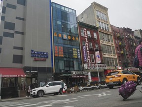 A six-story glass facade building, second from left, is believed to be the site of a foreign police outpost for China in New York's Chinatown, Monday April 17, 2023.
