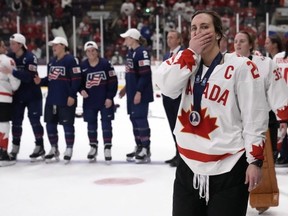 Canada captain Marie-Philip Poulin skates off with a silver medal after Team Canada lost the IIHF Women's World Hockey Championship gold medal match against the USA Sunday night. Frank Gunn/THE CANADIAN PRESS
