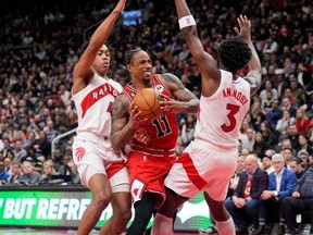 DeMar DeRozan #11 of the Chicago Bulls goes to the basket against O.G. Anunoby #3 and Scottie Barnes #4 of the Toronto Raptors during the second half of their basketball game at the Scotiabank Arena on February 28, 2023 in Toronto, Ontario, Canada. (Photo by Mark Blinch/Getty Images)