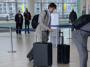 Mark Scheifele, who left Monday's game with an injury and did not return, arrives at the airport on Tuesday for the Jets trip to Vegas for Game 5 of their playoff series.