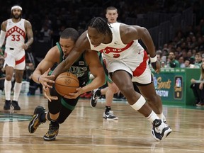 Raptors forward O.G. Anunoby (3) battles for a loose ball with Celtics forward Grant Williams (12) during the second quarter at TD Garden in Boston, Friday, April 7, 2023.