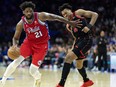 76ers centre Joel Embiid (21) dribbles past Raptors forward Scottie Barnes (4) during the third quarter at Wells Fargo Center in Philadelphia, March 31, 2023.