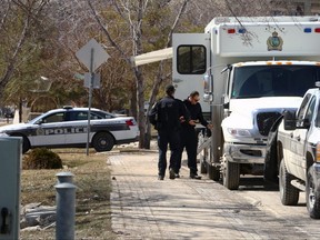 Vehicles from the Winnipeg Police Service underwater search and recovery unit, river patrol, and general patrol along Waterfront Avenue in Winnipeg on Mon., April 17, 2023. Police said human remains were found nearby. KEVIN KING/Winnipeg Sun
