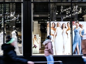 Pedestrians pass in front of a David's Bridal Inc. store in New York on Nov. 14, 2018.