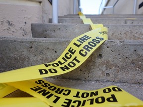 Police crime scene tape remained at Spruce Place S.W. on Sunday, April 16, 2023 after two deaths occurred in a public in that area on Saturday evening.