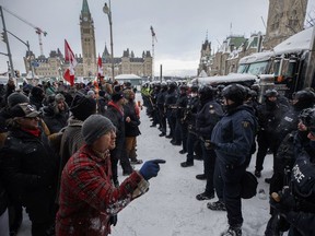 Police move in to clear downtown Ottawa near Parliament hill of protesters after weeks of demonstrations, on Feb. 19, 2022. A national civil liberties group is set to argue that "nebulous or strained claims" about economic instability or general unrest weren't enough to legally justify the Liberal government's use of the Emergencies Act early last year.