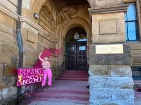 Climate activists at PM's offices in Langevin block. Ever the topless activist goes to Ottawa to paint the town pink and demand Climate Action Now! Source Twitter