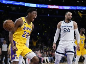 Los Angeles Lakers' Rui Hachimura (28) celebrates his dunk next to Memphis Grizzlies' Dillon Brooks (24) during the first half in Game 6 of a first-round NBA basketball playoff series Friday, April 28, 2023, in Los Angeles.