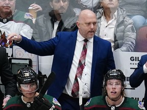 Arizona Coyotes head coach Andre Tourigny shouts instructions to his players during the third period of an NHL hockey game against the Boston Bruins Friday, Jan. 28, 2022, in Glendale, Ariz.